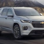 A silver 2022 Chevy Traverse is shown from the front driving on an open road during a 2022 Chevy Traverse vs 2022 Dodge Durango comparison.