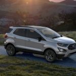 A silver 2022 Ford EcoSport is shown off-roading at sunset.