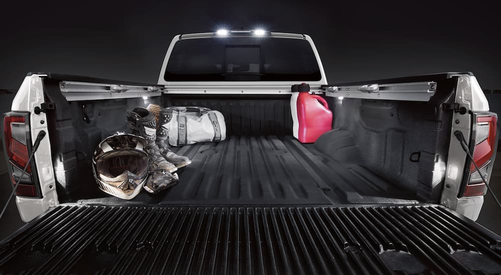 A silver 2022 Nissan Titan XD is shown from the rear.