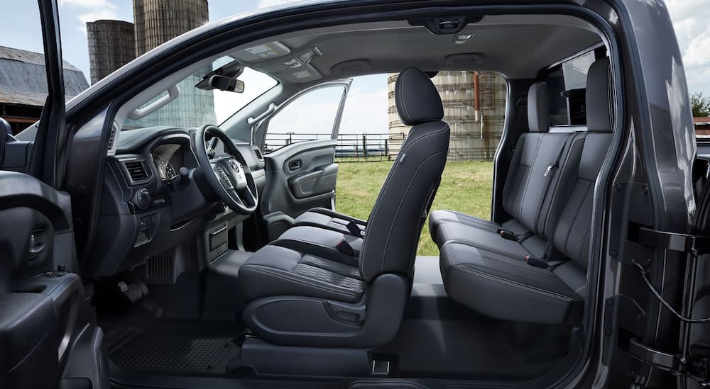 The black interior of a 2022 Nissan Titan shows two rows of seating.
