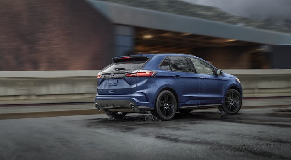 A blue 2022 Ford Edge ST is shown from the rear at an angle after winning a 2022 Ford Edge vs 2022 Honda Passport showdown.