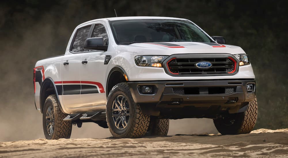 A white 2022 Ford Ranger Tremor is shown from the front at an angle while parked off-road.