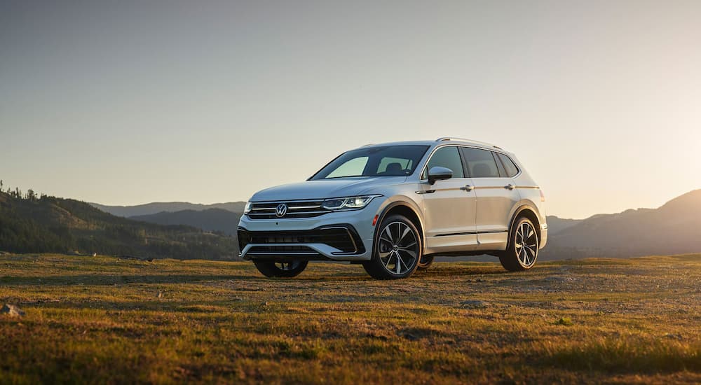 A white 2022 Volkswagen Tiguan is shown parked in an open field.
