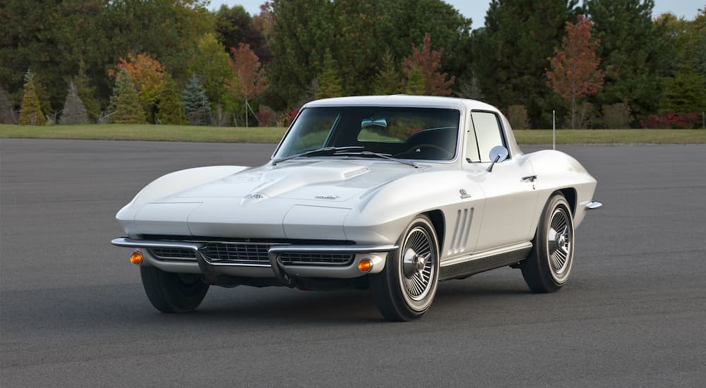 A white 1966 Chevy Corvette is shown parked on a tarmac after looking at a certified pre-owned Chevy.