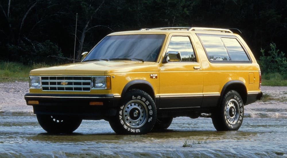 A yellow 1983 Chevy S10 Blazer is shown from the front at an angle.