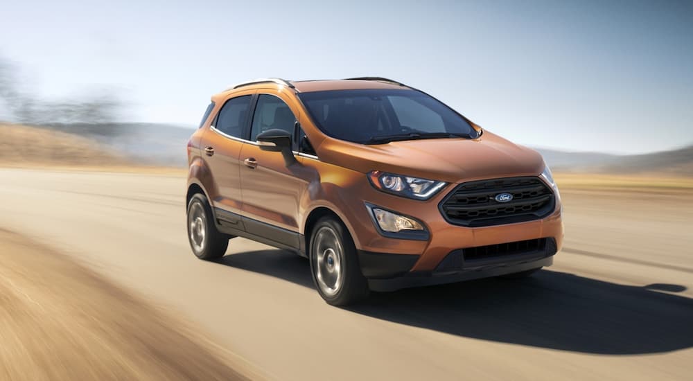 An orange 2022 Ford Ecosport is shown from the front at an angle during a 2022 Ford EcoSport vs 2022 Chevy Trax comparison.