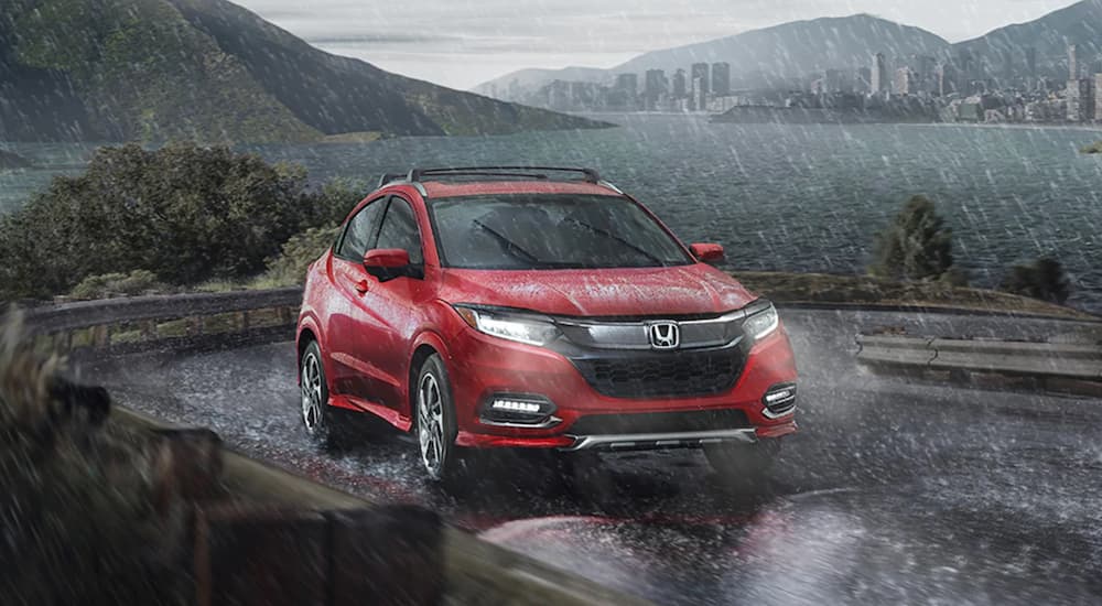 A red 2020 Honda HR-V is shown from the front at an angle in the rain.