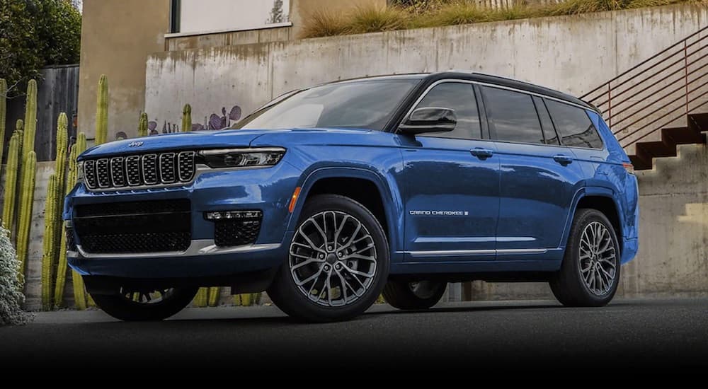 A blue 2022 Jeep Grand Cherokee WL is shown from the front at an angle during a 2022 Jeep Grand Cherokee WL vs 2022 Ford Explorer comparison.