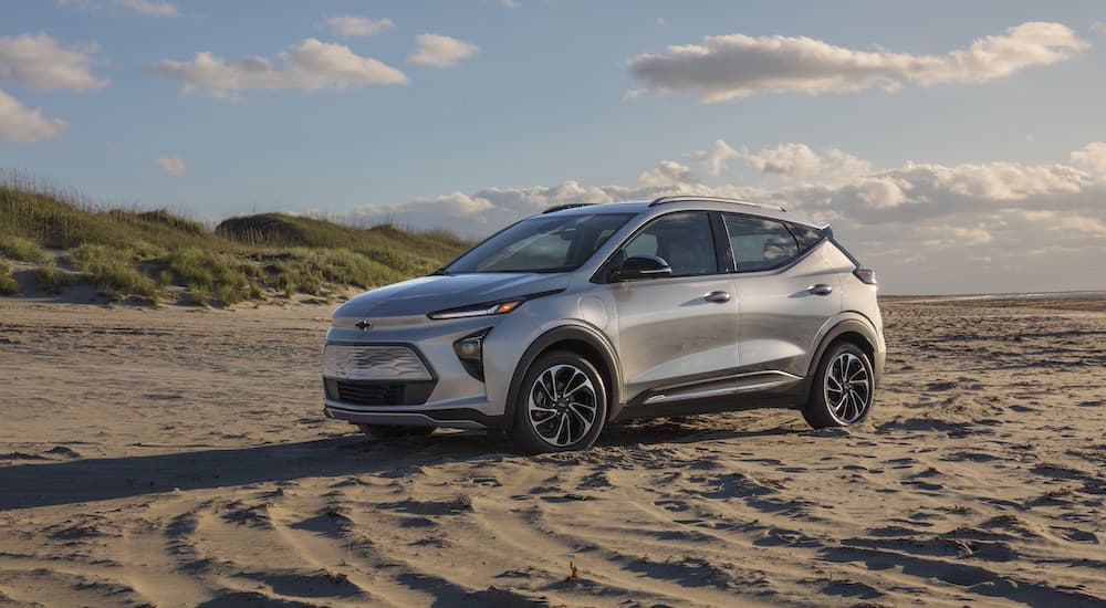A 2022 Chevy Bolt EUV is shown from the side while parked on the beach.
