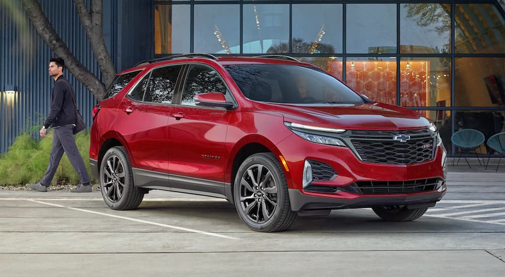 A red 2022 Chevy Equinox RS is shown speeding down a city street.
