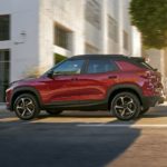 A red 2022 Chevy Trailblazer RS is shown from the side after leaving a used car dealership.