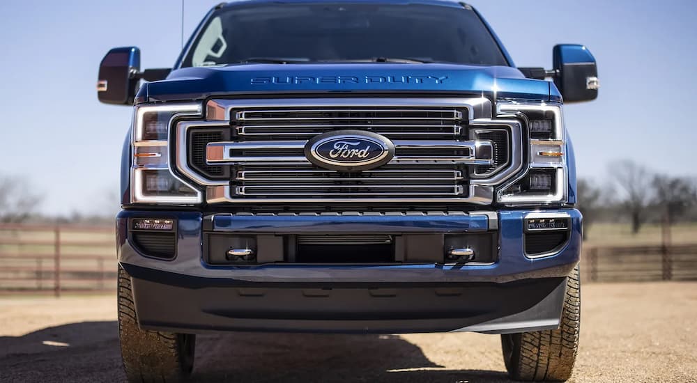 A blue 2022 Ford F-250 Super Duty is shown from the front parked at a ranch.