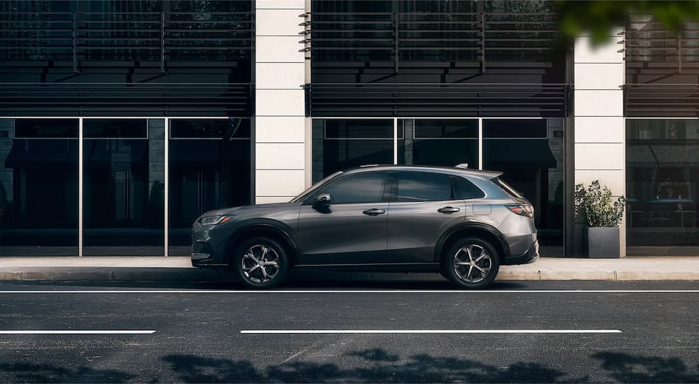 A grey 2023 Honda HR-V EX-L is shown from the side on a city street.