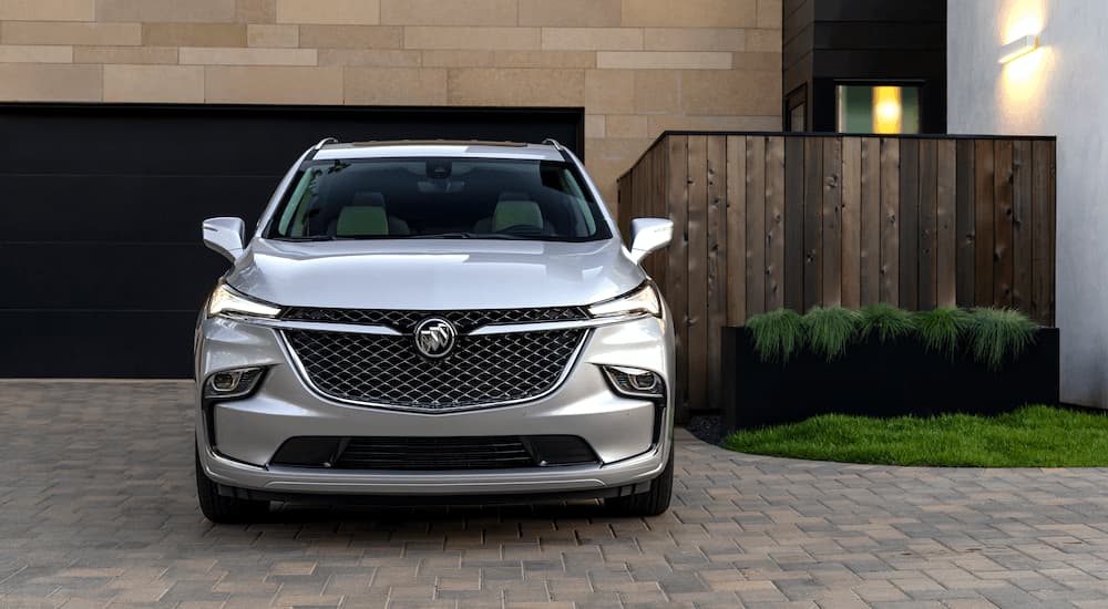A silver 2022 Buick Enclave Avenir is shown parked in a driveway.