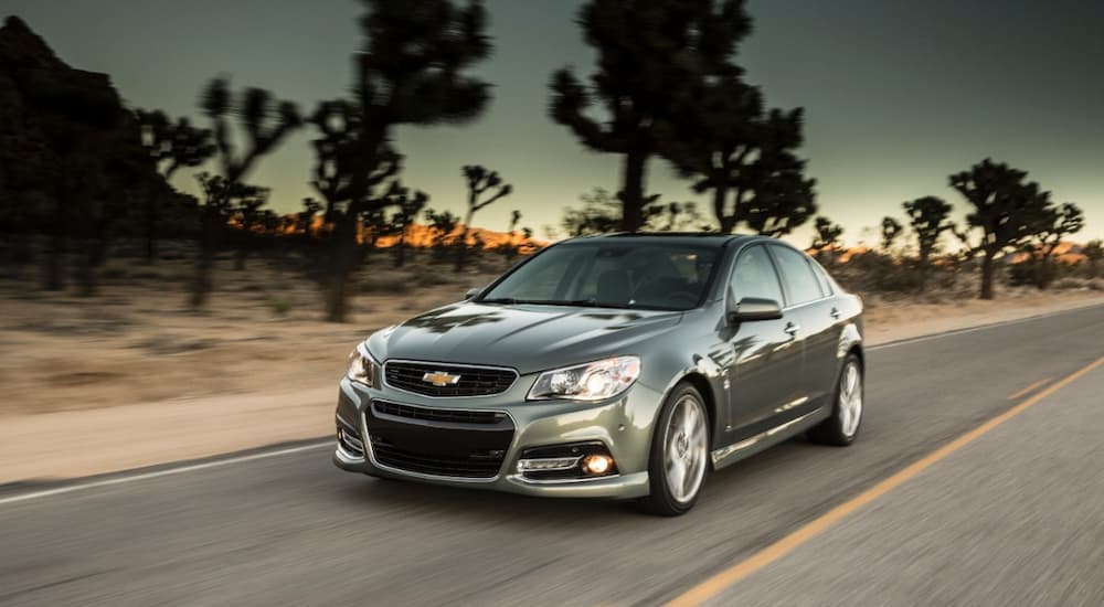 A grey 2014 Chevy SS is shown driving on an open road.
