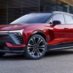 A red 2024 Chevy Blazer SS EV is shown parked at a Chevy dealer.