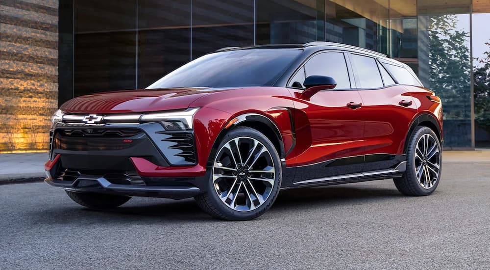 A red 2024 Chevy Blazer SS EV is shown parked at a Chevy dealer.