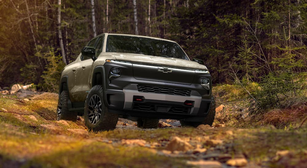 A tan 2022 Chevy Silverado Trail Boss is shown from the front while off-roading.