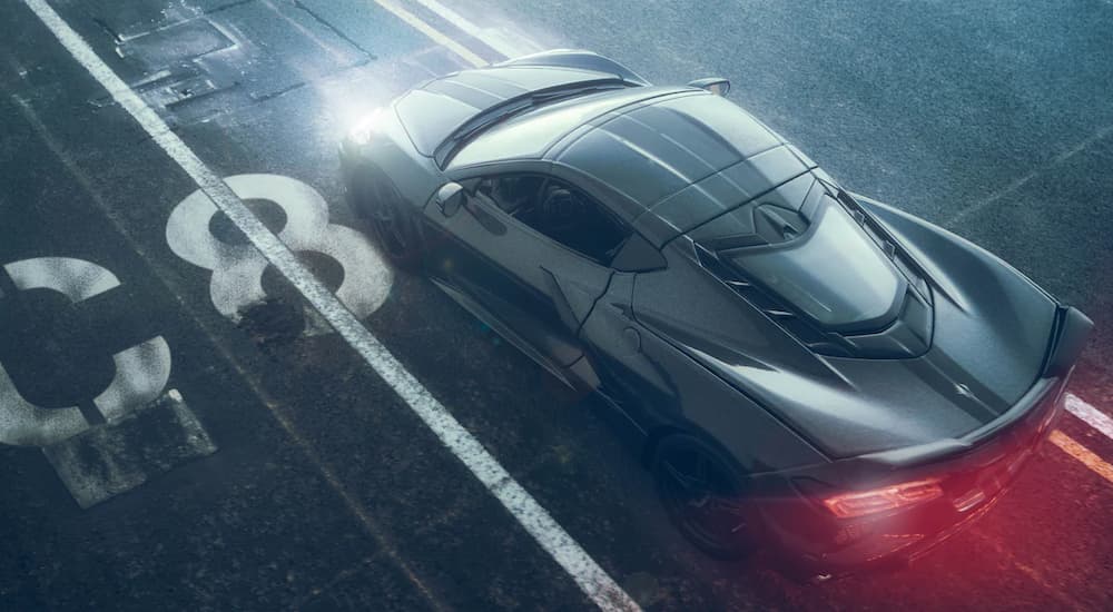 A grey 2022 Chevy Corvette is shown from a high angle driving on an airstrip.