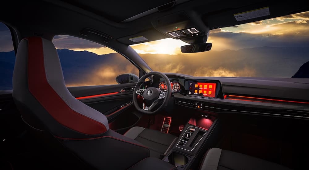 The interior of a 2022 Volkswagen Golf GTI Autobahn is shown from the rear seat.
