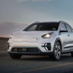 A white 2022 Kia Niro Ev is shown from the front at an angle after the owner searched 'Kia dealership'.