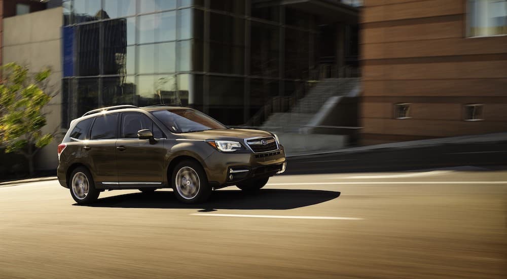 A brown 2017 Subaru Forester is shown driving on a city street.