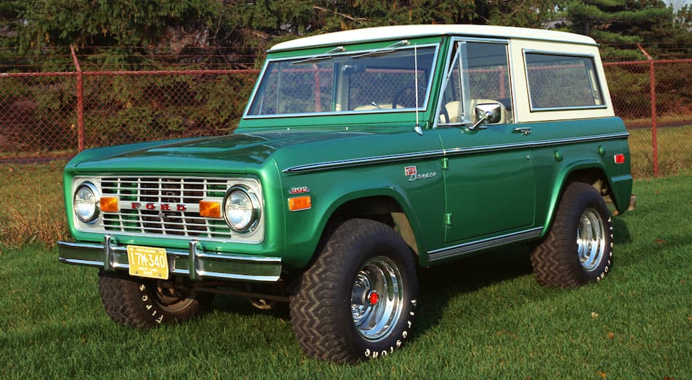A green 1971 Ford Bronco is shown from the front at an angle.