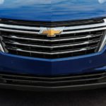 A close up of the grille of a blue 2022 Chevy Equinox is shown.