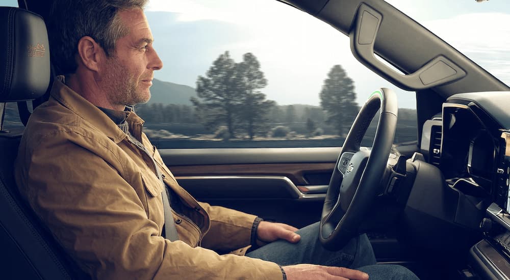 A man is shown using Super Cruise in a 2022 Chevy Silverado High Country.