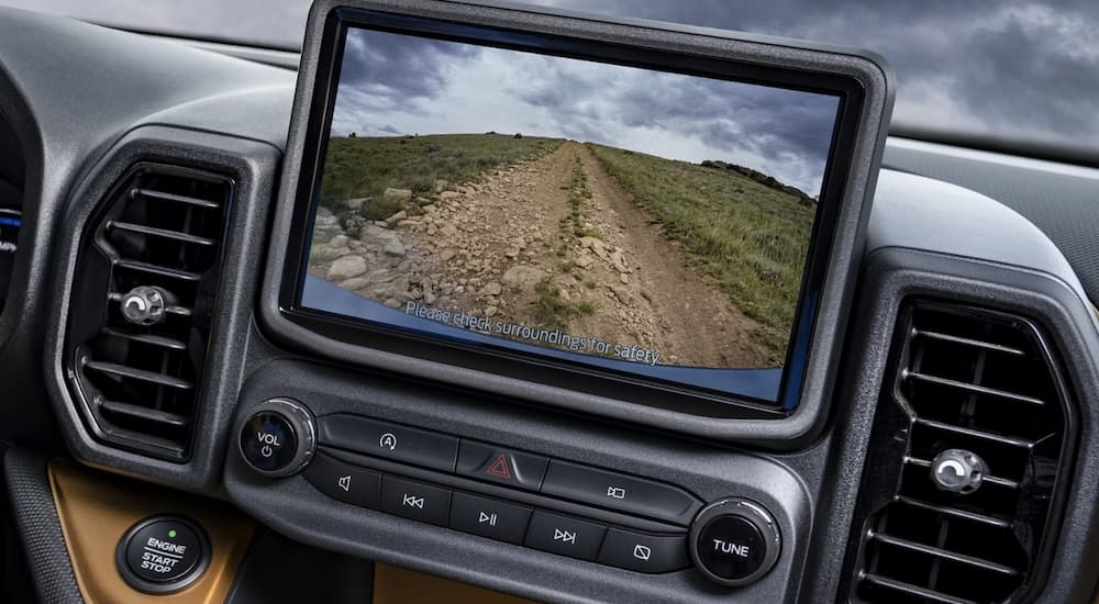 The infotainment screen in a 2022 Ford Bronco Sport Big Bend shows the dirt road.