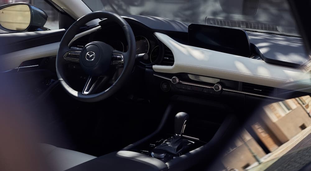 The interior of a 2022 Mazda3 is shown from behind the passenger seat looking forward.