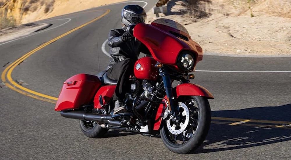 A red 2022 Harley-Davidson Street Glide Special is shown from the front at an angle while rounding a corner.