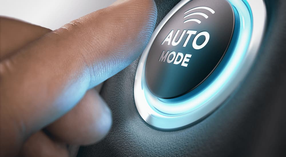 A person is shown pressing a button that says 'auto mode.'