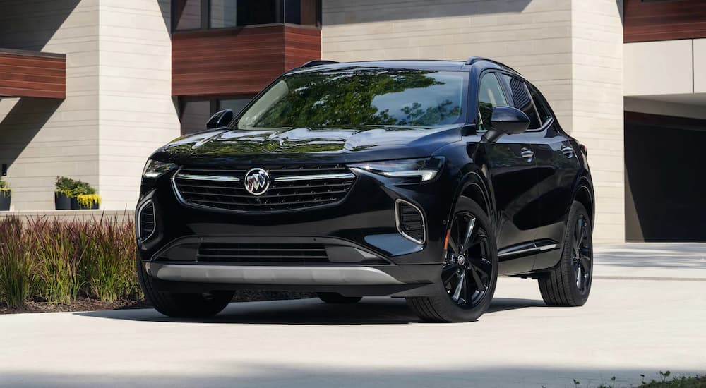 A black 2022 Buick Envision Avenir is shown parked in a driveway.