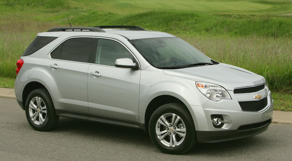 A white 2010 Chevy Equinox is shown driving on an open road.
