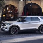 A silver 2022 Ford Explorer is shown from the side after leaving a Ford dealership.