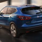A blue 2022 Nissan Qashqai is shown from the rear after leaving a Nissan dealer.