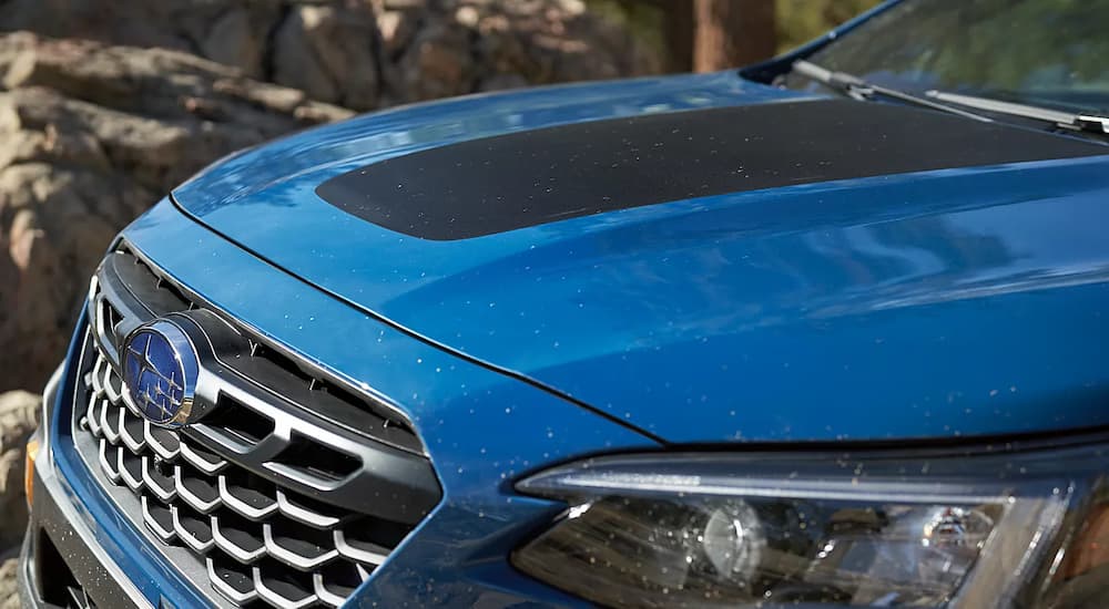 A close up of the hood of a blue 2022 Subaru Outback Wilderness is shown after leaving a Subaru dealer near you.