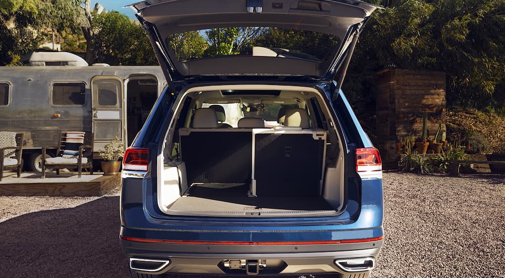 A blue 2022 Volkswagen Atlas is shown from the rear with the liftgate open.