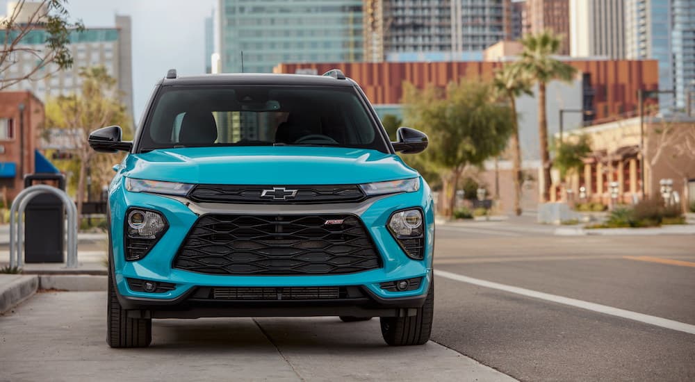 A teal 2021 Chevy Trailblazer RS is shown on a city street after visiting a used SUV dealership.