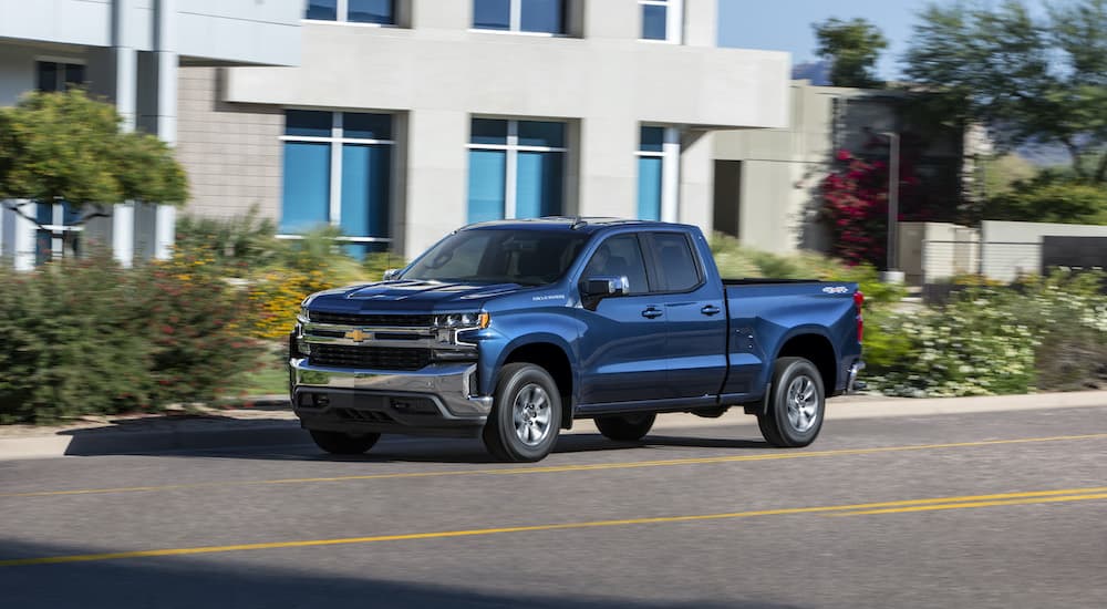 A popular used Chevy Silverado, a blue 2019 Chevy Silverado 1500 is shown parked in front of a building.