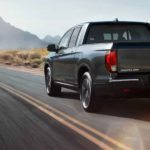 A 2020 Honda Ridgeline is shown from the rear after leaving a used truck dealership.