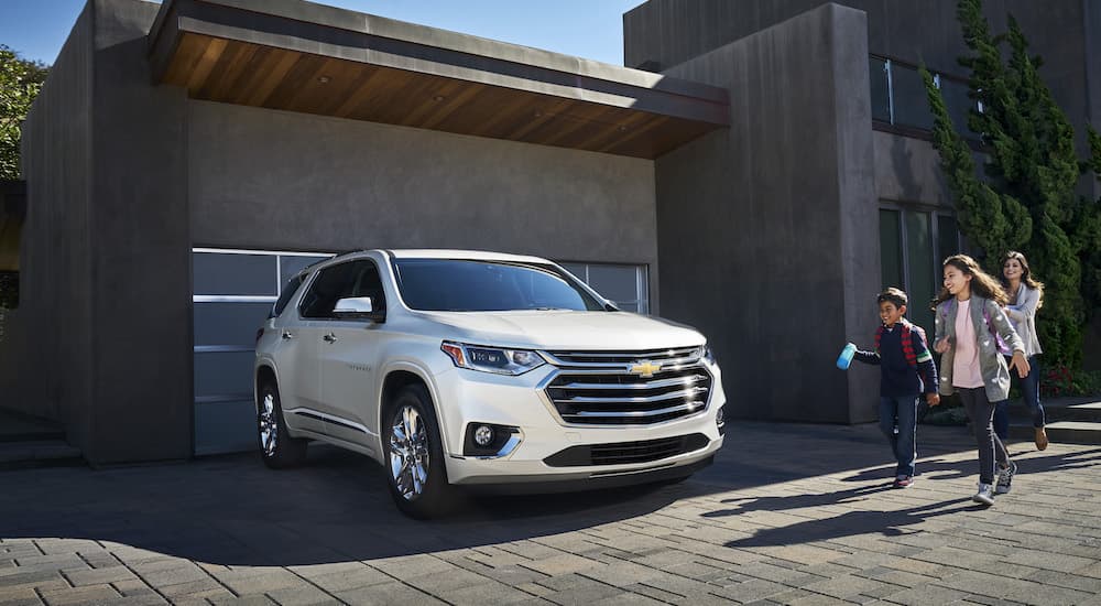 A 2023 Chevy Traverse is shown from the front at an angle while parked in front of a garage.