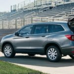 A grey 2022 Honda Pilot is shown from the rear while being loaded after leaving a dealer that had a Honda Pilot for sale.