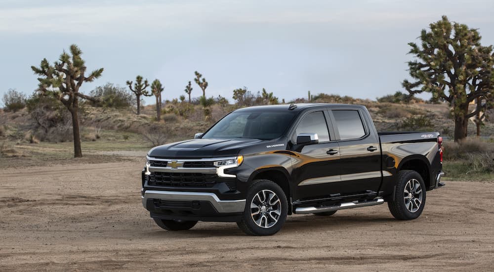 A black 2023 Chevy Silverado 1500 LT is shown parked in the driveway after leaving a Chevy dealership.