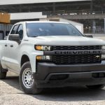 A white 2022 Chevy Silverado 1500 Commercial is shown at a work site.