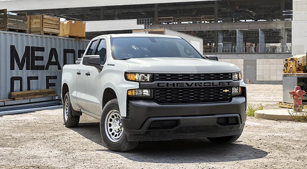 A white 2022 Chevy Silverado 1500 Commercial is shown at a work site.