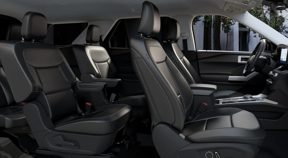 The black interior of a 2022 Ford Explorer Limited shows two rows of seating.