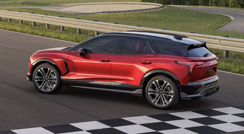 A red 2024 Chevy Blazer EV SS is shown on a racetrack.