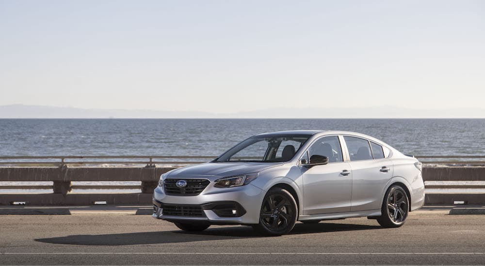 A silver 2020 Subaru Legacy Sport is shown parked on a coastal road after leaving a dealership that advertised having a used Subaru Legacy.